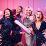 glamorous contented women smart dresses looking ahead